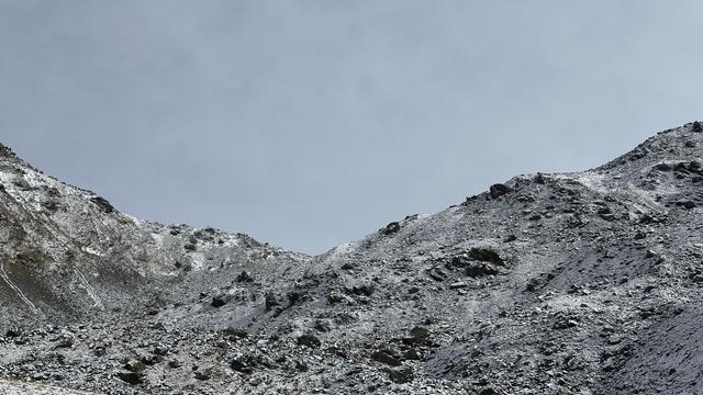 View of the Furcletta pass (2,735 m) from below. The scree slopes leading up to the pass are covered in a light snow.