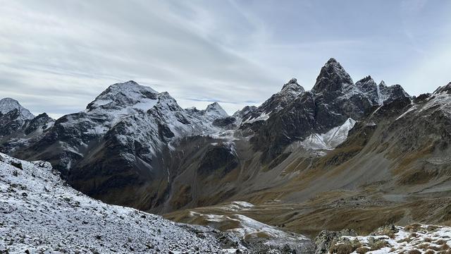 View looking west from Furcletta towards Val Tuoi. Piz Fliana (left) and Little and Big Piz Buin (right) have snow on their peaks.