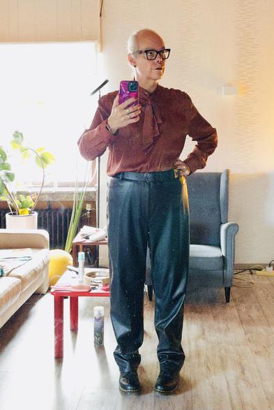 I'm wearing a satin blouse with a large pussybow. It's black and copper striped. The trousers are faux leather straight legged pants and I'm also wearing black Doc Martens boots, the Vondas with red rose embroidery on them.